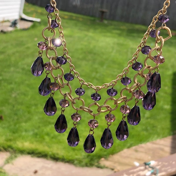 Gold tone festoon necklace with purple glass crystals