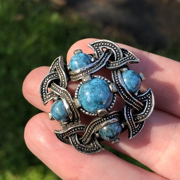 costume jewelry Celtic style brooch with mottled blue glass stones.