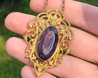 Gilt brass and purple glass early 20th century pendant necklace, very ornate.