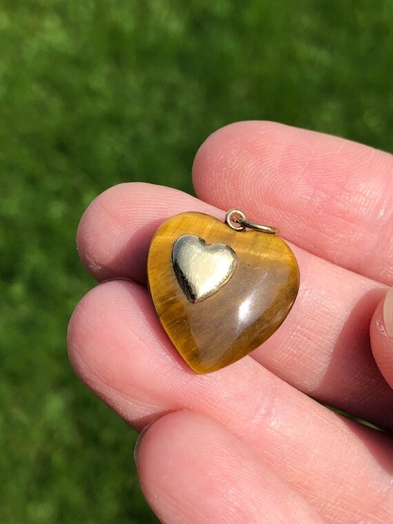 Carved tigers eye heart pendant with applied heart