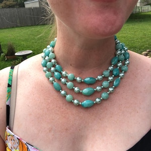 Triple strand blue acrylic necklace marked Hong Kong