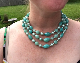 Triple strand blue acrylic necklace marked Hong Kong