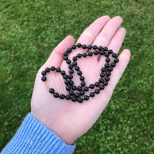 14k gold clasp black onyx beaded necklace, individually knotted
