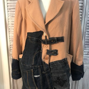 May include: A tan wool blazer with denim patches and a single button fastening. The blazer has a long, loose fit and is made of a soft, comfortable fabric.