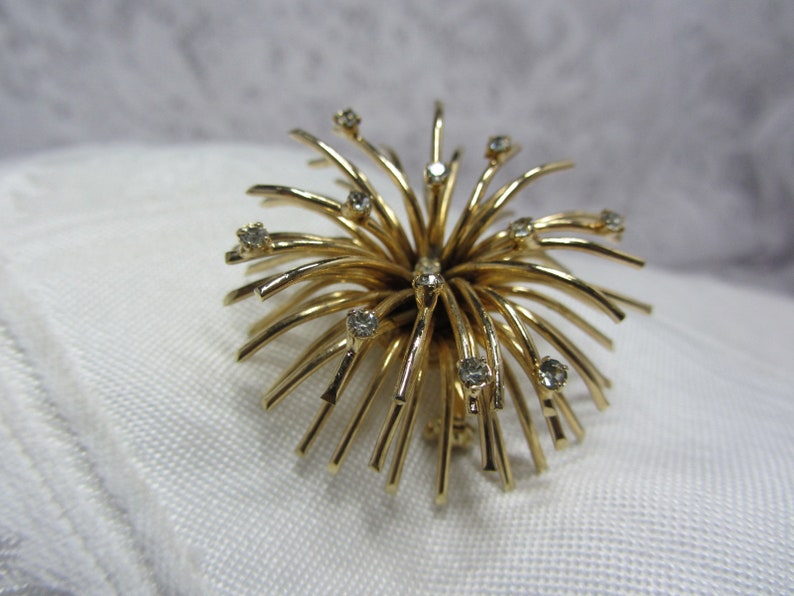 Berg\u00e9re Gold Tone and Clear Rhinestone Burst Brooch and Matching Clip Earrings