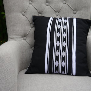 Black and white monochrome cushion, black and white striped cushion with white embroidery