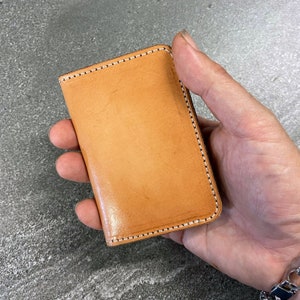 Natural leather vertical card wallet.