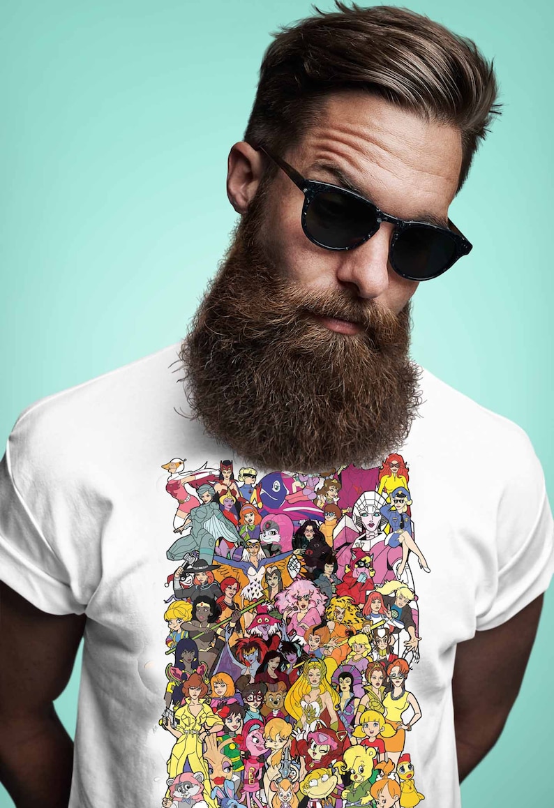 May include: A white t-shirt with a colorful graphic print of cartoon female characters. The graphic features a variety of characters with different hairstyles, clothing, and poses.