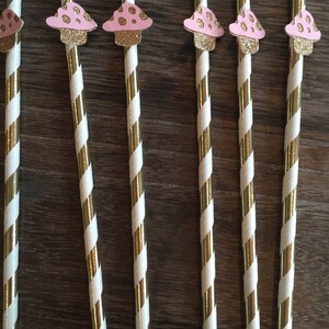 May include: Set of six gold and white striped paper straws with pink and white mushroom toppers.