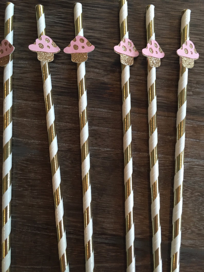 May include: Set of six gold and white striped paper straws with pink and white mushroom toppers.