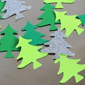 May include: Assortment of green, lime green, and silver glitter Christmas tree confetti. The confetti is made of paper and is perfect for adding a festive touch to any craft project.