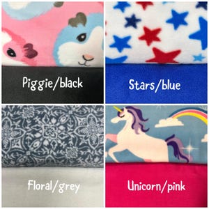 May include: A four-panel grid of fabric swatches. Top left: pink and blue guinea pig print over black. Top right: red and blue stars on white over solid blue. Bottom left: grey floral pattern over solid grey. Bottom right: unicorn and rainbow print over solid pink.