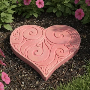 May include: A pink heart-shaped stepping stone with a swirling design. The stone is surrounded by pink and purple flowers and green foliage, creating a garden setting. A decorative garden accent.