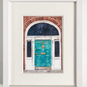 May include: A watercolour painting of a teal green door with a brass door knocker and a brass letterbox. The door is framed by a white door frame and a brick archway. The door is set against a brick wall.