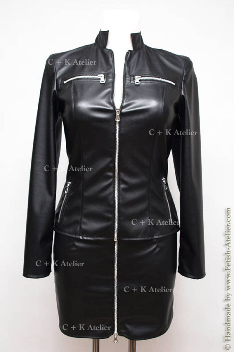 May include: A black leather jacket and skirt set with a zipper closure and silver hardware. The jacket has a stand-up collar and long sleeves. The skirt is a mini skirt. The set has the text "C+K Atelier" printed on it.