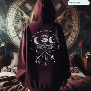 Embrace the power of Hecate with our Crossroads Hoodie. This divine feminine design honors the Moon Goddess and her symbolism of the crossroads, perfect for those who believe 'Not All Who Wander the Crossroads Are Lost