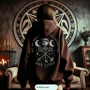 Embrace the power of Hecate with our Crossroads Hoodie. This divine feminine design honors the Moon Goddess and her symbolism of the crossroads, perfect for those who believe 'Not All Who Wander the Crossroads Are Lost