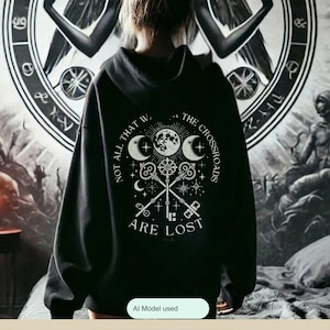 Embrace the power of Hecate with our Crossroads Hoodie. This divine feminine design honors the Moon Goddess and her symbolism of the crossroads, perfect for those who believe 'Not All Who Wander the Crossroads Are Lost