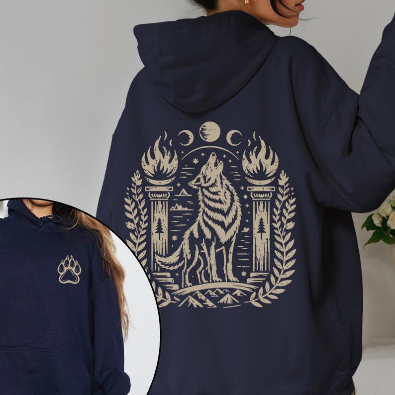 Hoodie with beige howling wolf and triple moon design. Navy hoodie with same design. Maroon hoodie with back wolf design and small front paw print. Black and dark chocolate hoodies shown on models, with front and back views.