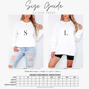 May include: A size guide for a Gildan 18000 unisex crewneck sweatshirt. The image displays two white sweatshirts in sizes S and L, alongside a table listing width, length, and sleeve length measurements in inches for sizes S through 5XL.