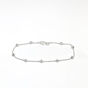 May include: A silver chain bracelet with small round beads.