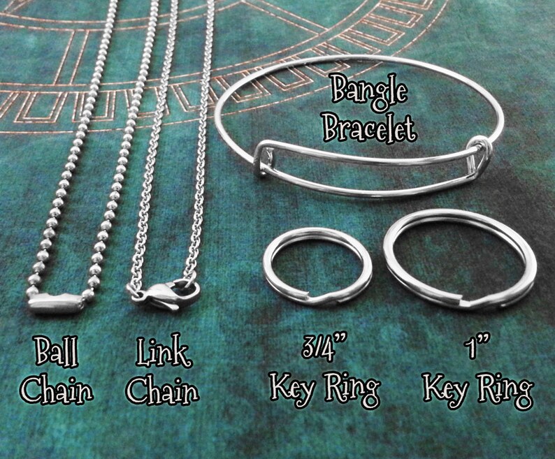 May include: A close-up of five different silver chains and key rings. The chains include a ball chain, a link chain, and a bangle bracelet. The key rings are 3/4 inch and 1 inch in diameter.