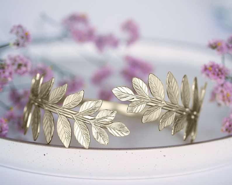 May include: Gold leaf wreath with a delicate design, perfect for adding a touch of elegance to any occasion.