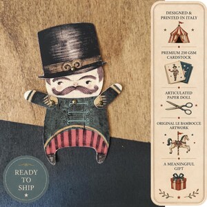 May include: An articulated paper doll featuring a character with a mustache wearing a black top hat and a dark jacket with red striped trousers. The design includes metal fasteners at the shoulders. A vertical panel displays text and icons.