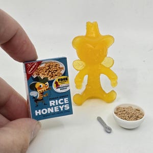 May include: A set of three ceramic mugs with a speckled, matte finish. Each mug features a different color: light blue, cream, and gray. The mugs have a simple, modern design, perfect for coffee or tea.