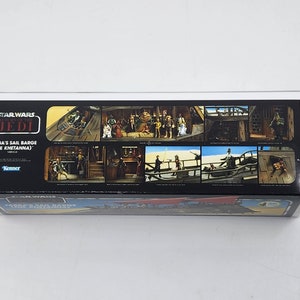 May include: A Star Wars Return of the Jedi Kenner toy box featuring Jabba's Sail Barge (The Khetanna). The box has a black background with a white border and shows multiple images of the toy and characters from the film.