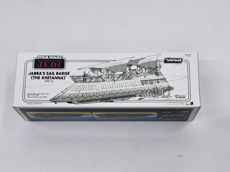 May include: A white box featuring a black and white illustration of Jabba's Sail Barge (The Khetanna) from Star Wars: Return of the Jedi. The box is labelled "Star Wars: Return of the Jedi Vintage Collection" and "Jabba's Sail Barge (The Khetanna)".