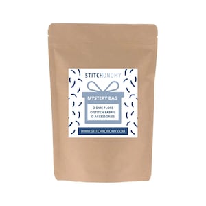 May include: A brown paper bag with a blue and white label that says "Stitchonomy Mystery Bag" and includes the text "0 DMC Floss 0 Stitch Fabric 0 Accessories" and "www.stitchonomy.com".