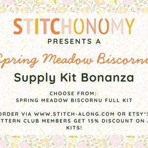 May include: A promotional graphic for a Spring Meadow Biscornu Supply Kit Bonanza. The text is in orange and green, with a floral border. The kit includes a full kit and is available via website or Etsy.