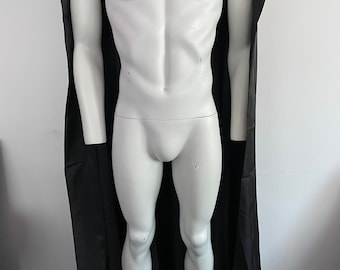 May include: A black satin cape with a high collar. The cape is draped over a white mannequin.