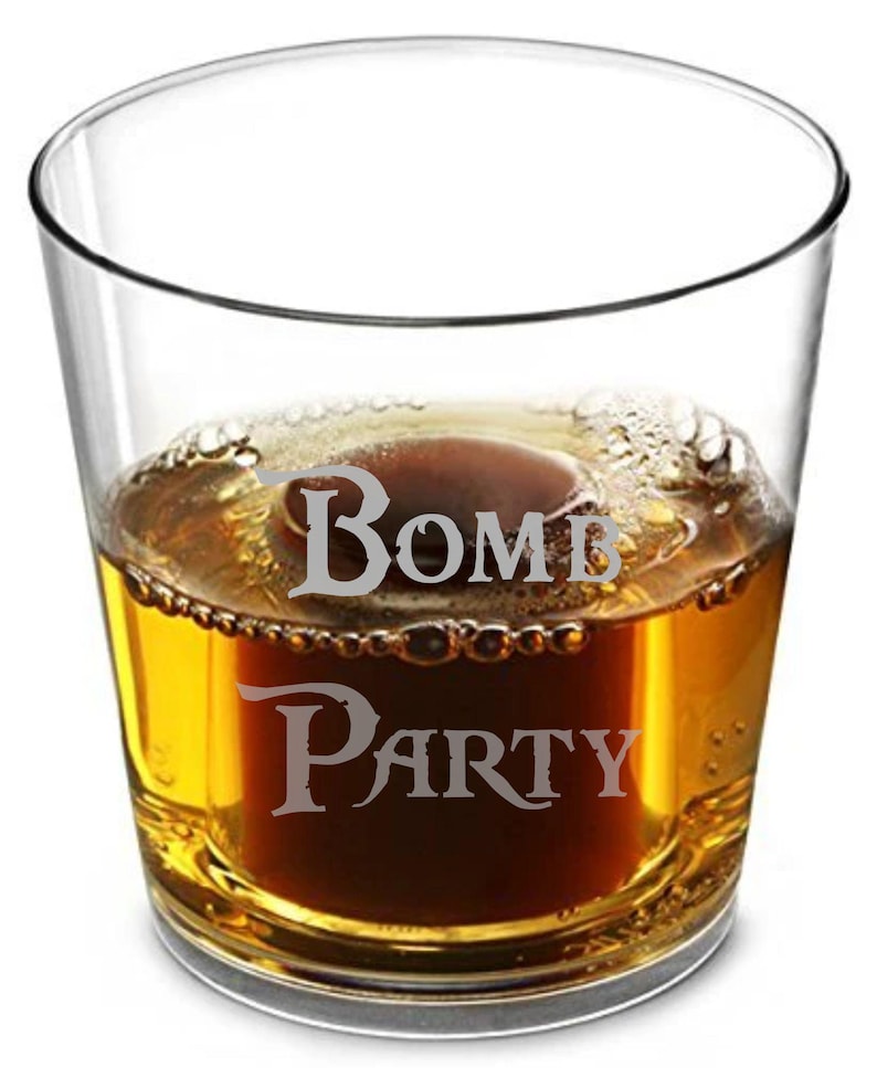 May include: A clear glass tumbler with the words "Bomb Party" etched on the side. The glass is filled with a dark amber liquid, possibly a cocktail or spirit, with a foamy top.