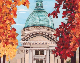 May include: A white building with a large dome and a cross on top. The building is surrounded by trees with red and orange leaves. The building has a large entrance with a wooden door. The building is set against a blue sky with white clouds.