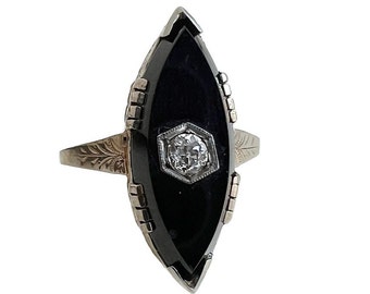 May include: A gold ring with a black onyx marquise-shaped stone and a small diamond in the center.