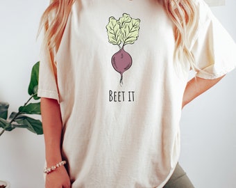 May include: A cream colored t-shirt with a drawing of a beet and the text "BEET IT" on the front.