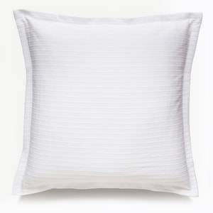 May include: White pillow with a textured, horizontal stripe pattern. The pillow has a white border and is made of a soft, comfortable fabric.