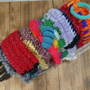 May include: A colorful crocheted arm warmer with a red crocheted cuff and a faux fur trim. The arm warmer is made with a variety of textures and colors, including pink, purple, blue, green, yellow, and orange.