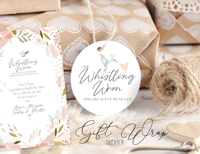 May include: A white round gift tag featuring a light blue bird and pink heart design. The text "The Whistling Wren Online Gifts Retailer" is printed on the tag.