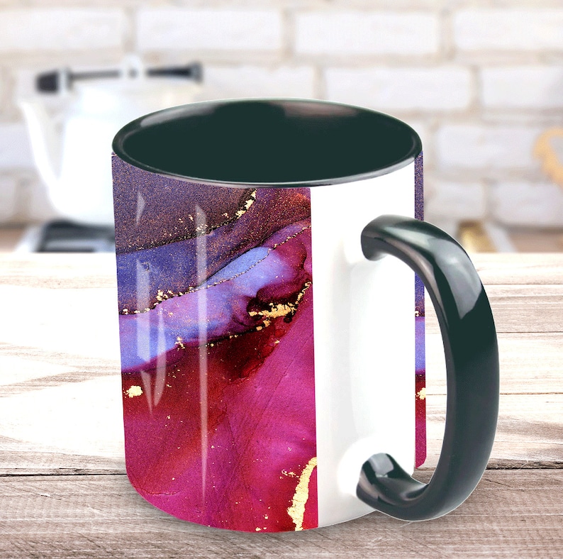 May include: A white ceramic mug with a black handle and rim. The mug features an abstract design with shades of purple, pink, and gold.