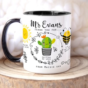 May include: White ceramic mug with a black handle and rim. The mug features a cartoon illustration of a sun, a cactus, and a bee. The text on the mug reads "Mr Evans Thank you for... Helping me grow From Maisie xxx".