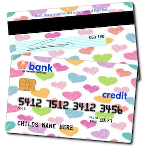 May include: A white plastic credit card with a colorful heart pattern. The card has the text "bank" and "credit" on it. The card also has the text "5412 7512 3412 3456" and "CHILDS NAME HERE".