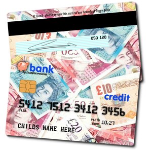 May include: A plastic credit card with a design of British pound notes. The card has the text "Bank by Foamdecorations" and "credit" on it. The card number is 5412 7512 3412 3456. The expiration date is 10/27.