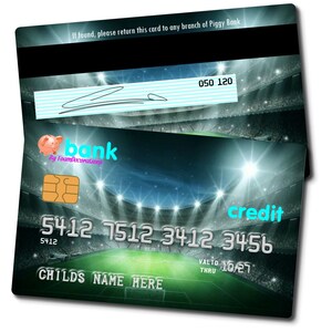 May include: A green and black credit card with a soccer stadium background. The card has the text "credit" in blue, "bank" in pink, and "By FoamDecorations" in white. The card number is 5412 7512 3412 3456. The card also has the text "VALID 10/27 THRU" and "CHILDS NAME HERE".