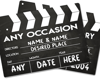 May include: Black and white clapboard with the text "ANY OCCASION" and spaces for names, location, date, and year. The text "DIRECTORS", "LOCATION", "DAY", "MONTH", "YEAR", and "ANY DATE HERE" are also printed on the clapboard.