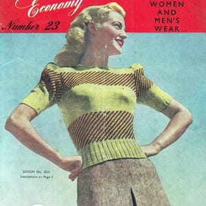 May include: Vintage magazine cover featuring a woman wearing a green and brown striped sweater and a brown skirt. The magazine title reads "Economy" and "Number 23". The cover also includes the text "Women and Men's Wear" and "Design No. 3051".