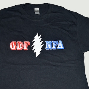 May include: Black t-shirt with a white lightning bolt graphic and the text "GDF NFA" in red, white, and blue.