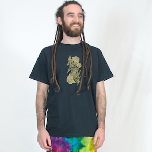 May include: A black t-shirt with a gold lightning bolt and roses graphic. The shirt is being worn by a person with long dreadlocks.